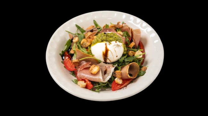 FOODURO salad with burrata, cured meat, tomatoes, and greens